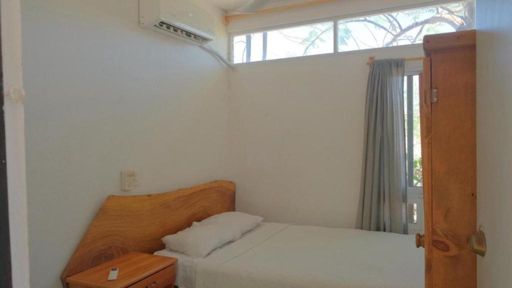 Ένα ή περισσότερα κρεβάτια σε δωμάτιο στο Casa Firefly