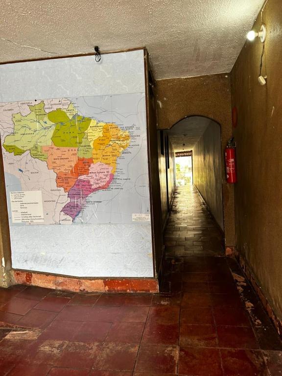 a hallway with a large map on a wall at Guest House BH in Belo Horizonte