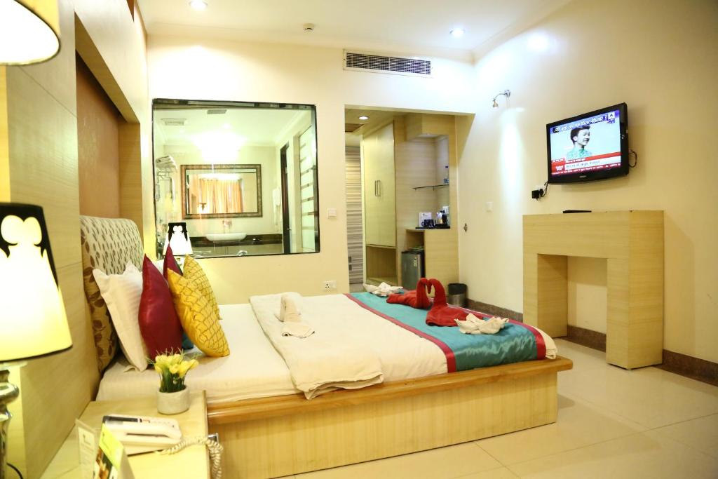 Postel nebo postele na pokoji v ubytování Hotel Rajshree & Spa