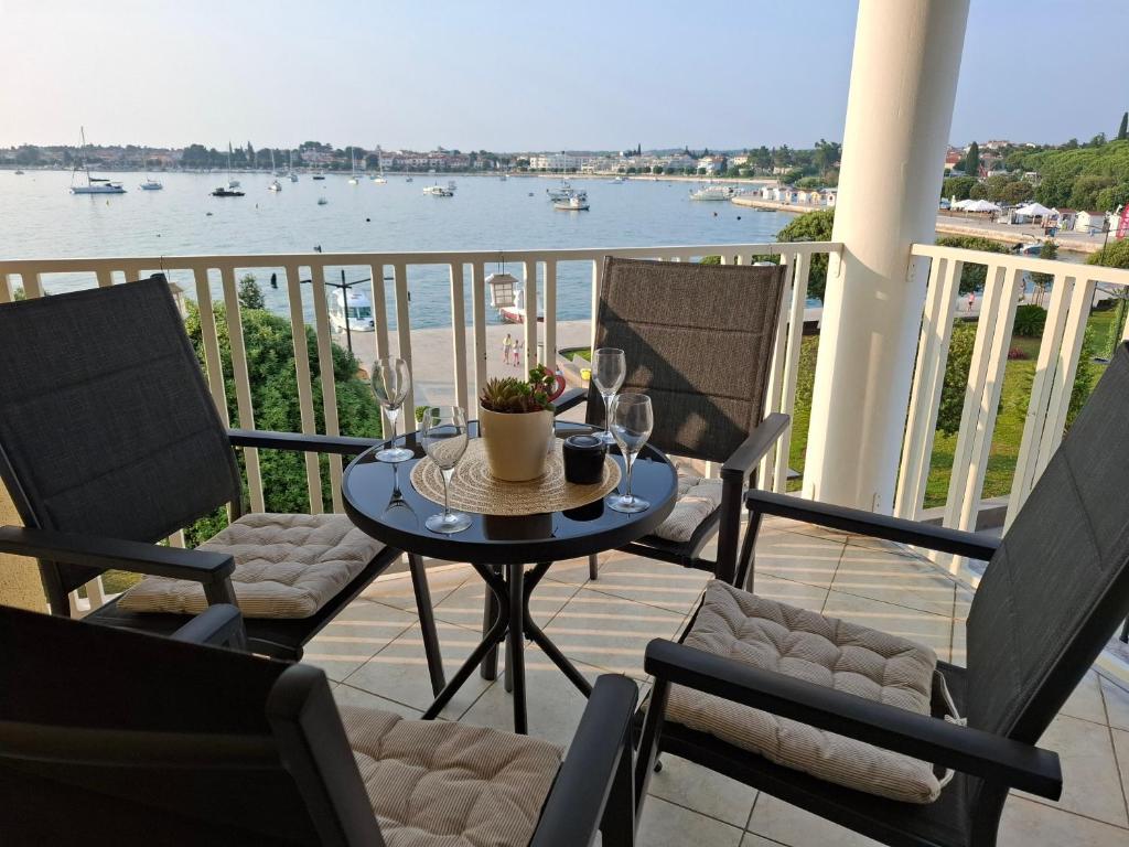 a table and chairs on a balcony with a view of the water at Bella Vista Superior in Umag