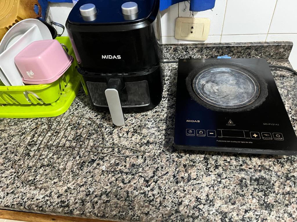 a counter top with a coffee maker and a blender at Depar R&L in Encarnación