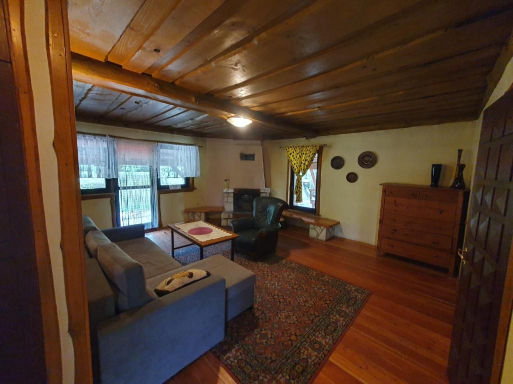 a living room with a couch and a table at Domki Bartoszówka 