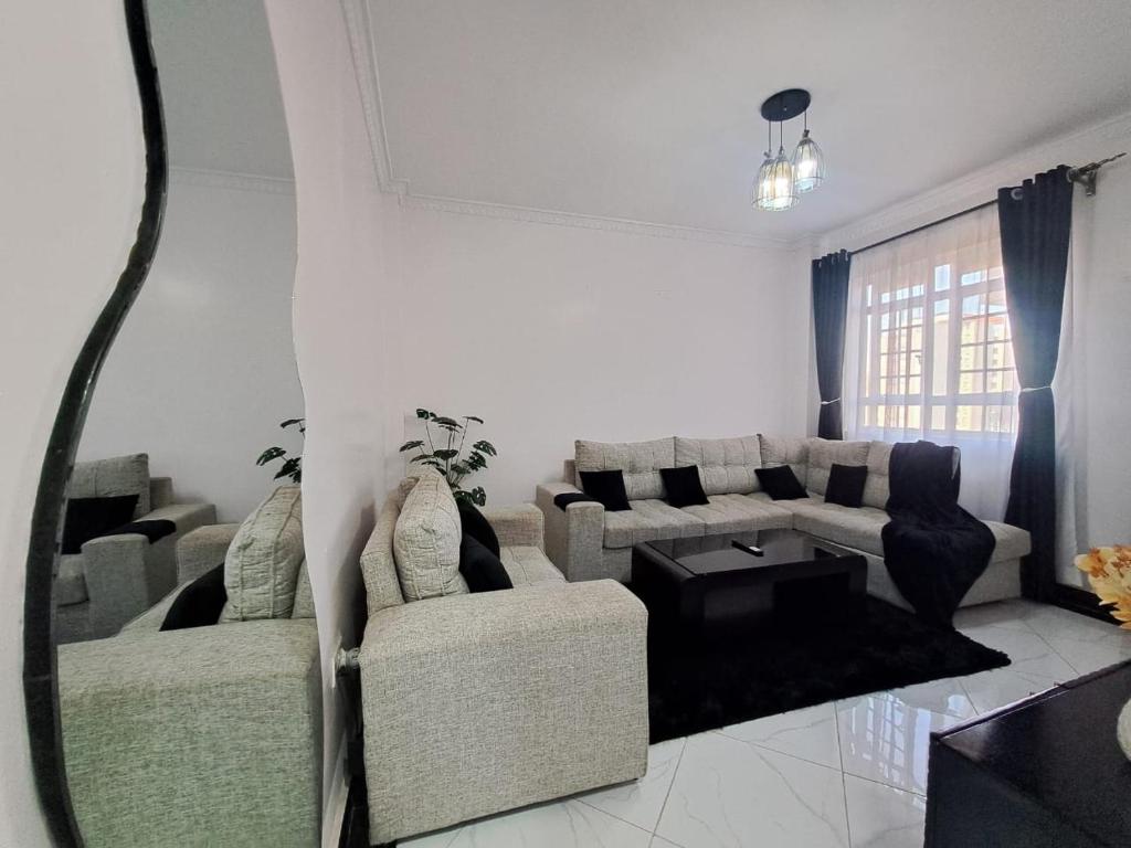 a living room with a couch and a table at Del's Homes -Ruiru in Ruiru