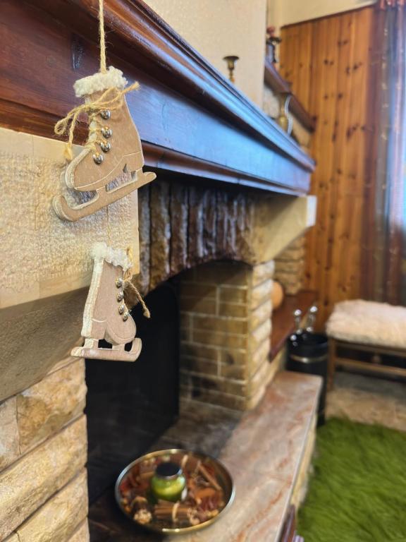 a christmas ornament hanging in front of a fireplace at Lydias house II in Arachova