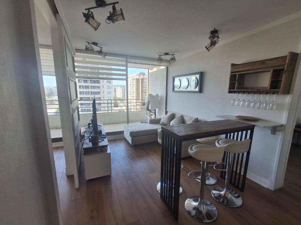 a living room with a couch and a table and chairs at Departamento centro Viña del Mar in Viña del Mar