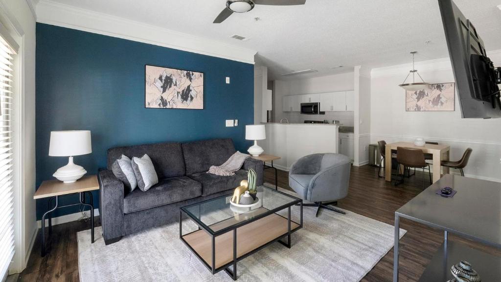 a living room with a couch and a table at Landing Summerville Apartments in Summerville