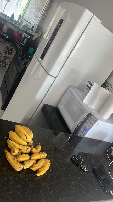 a bunch of bananas sitting on a counter in a kitchen at Carmela temporada Balneário de IRIRI Espírito Santo ES in Iriri