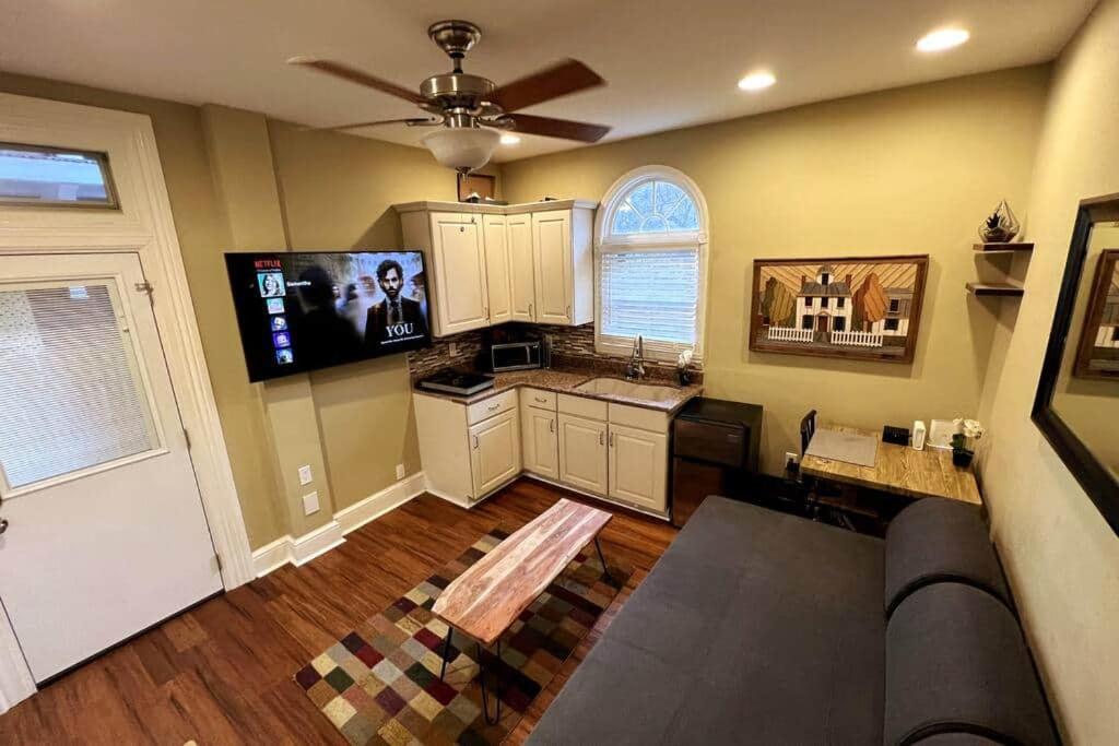 a living room with a ceiling fan and a kitchen at THE ADDAMS HOUSE - LANCASTER HISTORIC DISTRICT in Lancaster