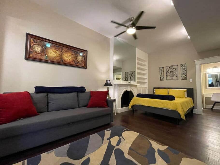 a living room with a couch and a bed at THE STEVENS STUDIO - HISTORIC DOWNTOWN LANCASTER in Lancaster