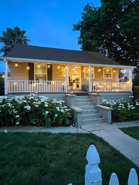 a house with a porch with lights on it at Walk to Downtown | Workspace + Pet Friendly in Pleasanton