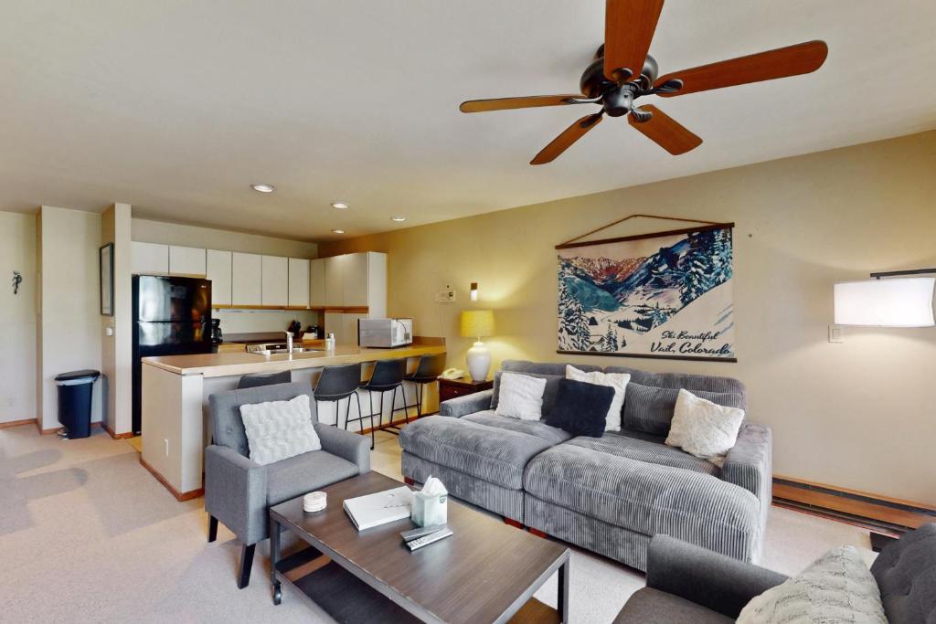 a living room with a couch and a ceiling fan at Simba Run 2305 in Vail