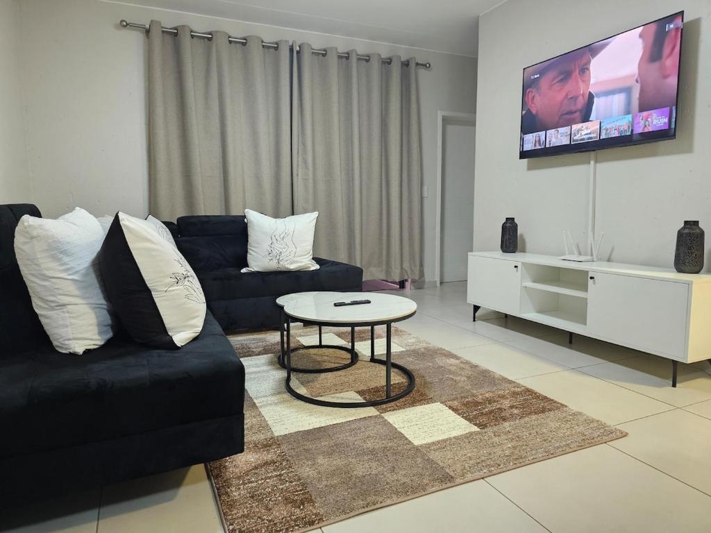 a living room with a couch and a table at Eland Ridge in Boksburg