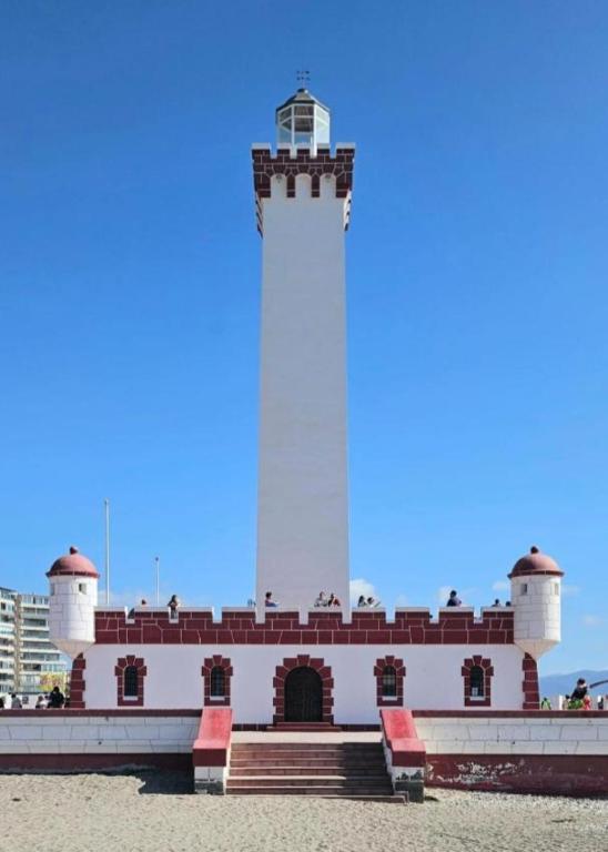 a lighthouse sitting on top of a building at Pieza en el centro de La serena in La Serena