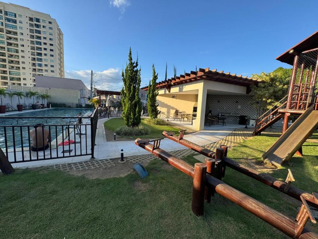 a bunch of logs in the grass near a building at Casa Arruda Climatizada 5 proximo shopping boulevard in Vitória da Conquista