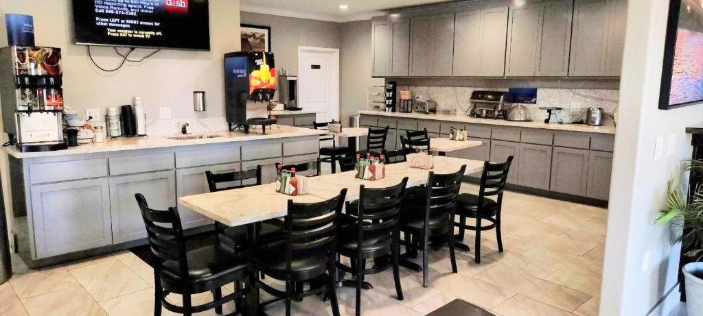 a restaurant with tables and chairs in a kitchen at Anderson Inn in Anderson