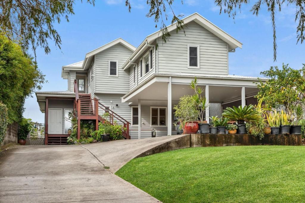 a white house with a lawn in front of it at Urunga Magic. in Urunga