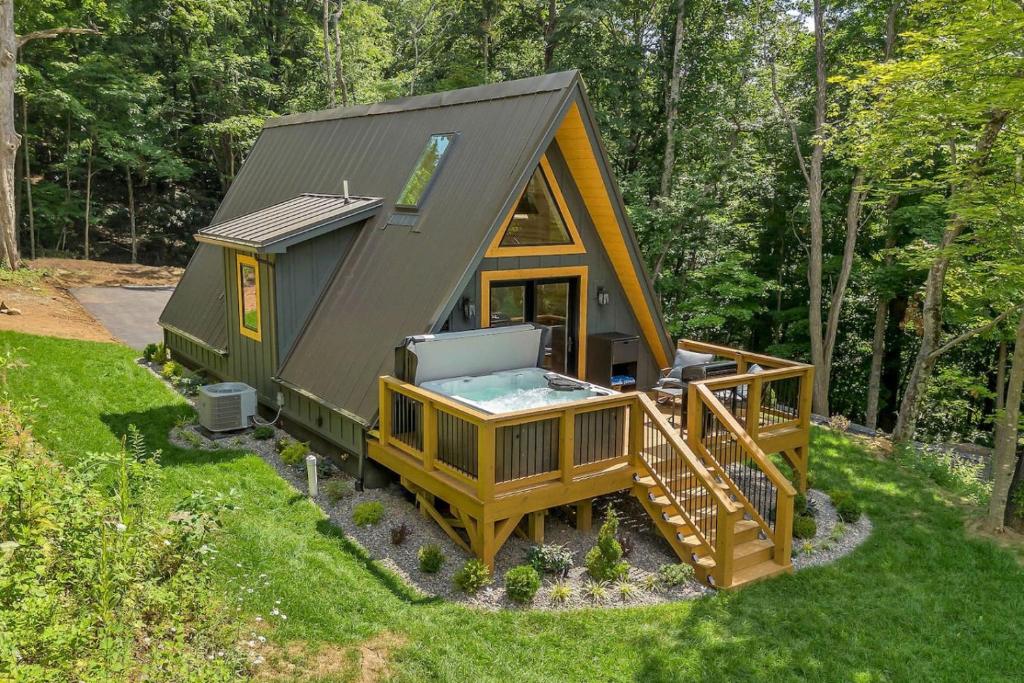 a tiny house with a pool and a deck at High Peak At West Jefferson A Frame in West Jefferson