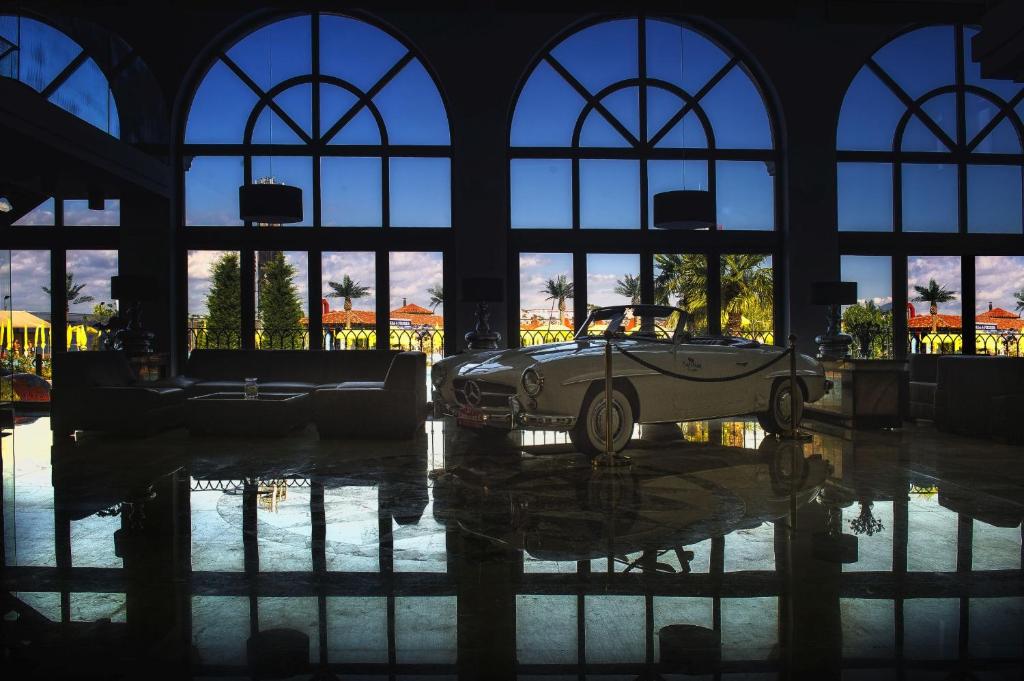 a car is sitting in a room with windows at Villa Plaza Boutique Hotel & Spa in Prešov