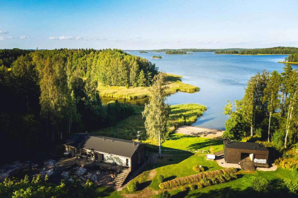 an aerial view of a house on the shore of a lake at Stay North - Rönnäs in Loviisa