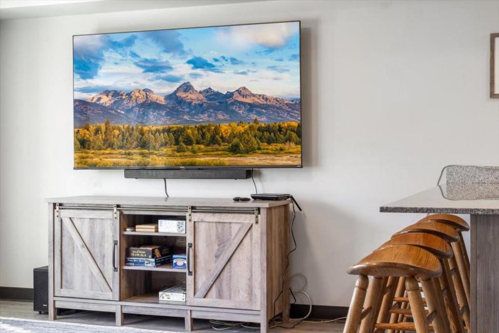 a living room with a flat screen tv on a wall at Lorene St Condo in Rexburg