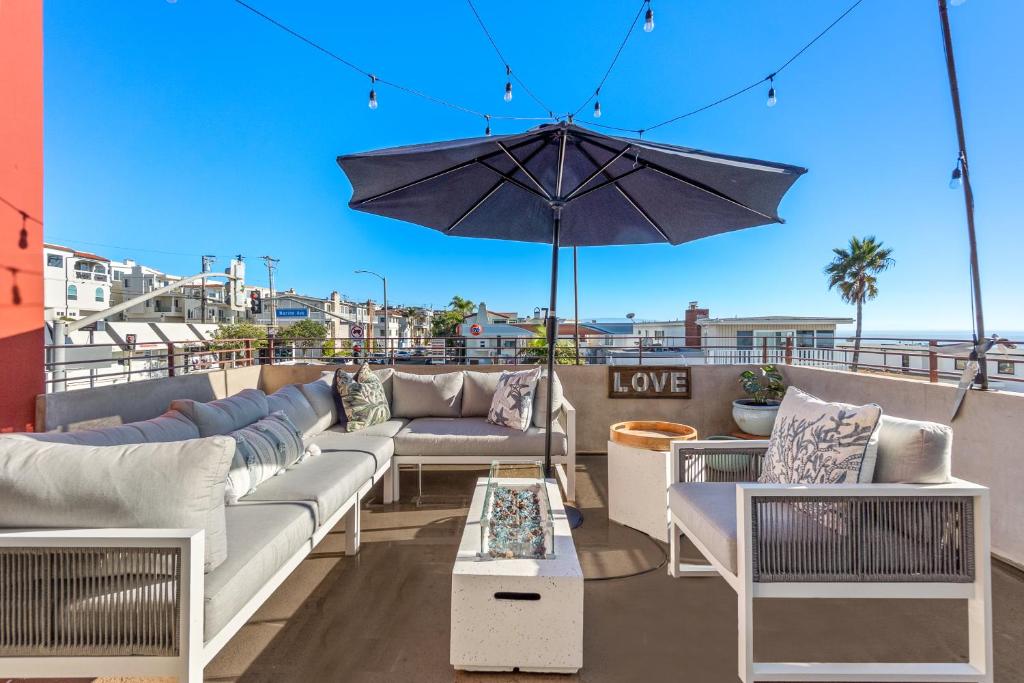 マンハッタン・ビーチにあるOcean View condo in the heart of Manhattan Beachのパティオ(ソファ、屋上パラソル付)