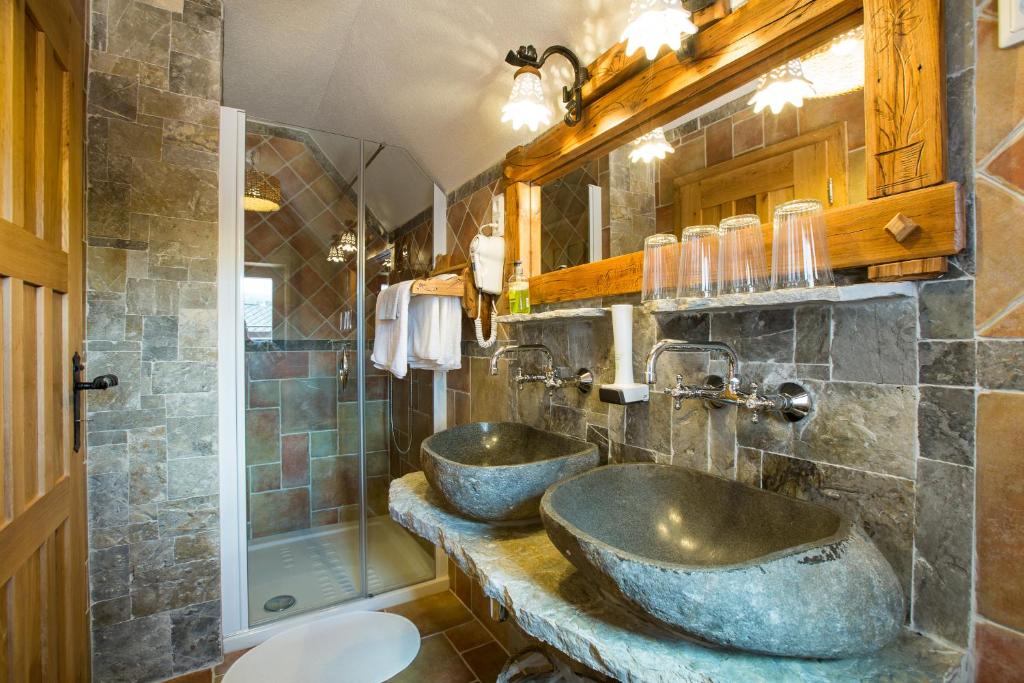 a bathroom with two sinks and a shower at Old Bled House in Bled