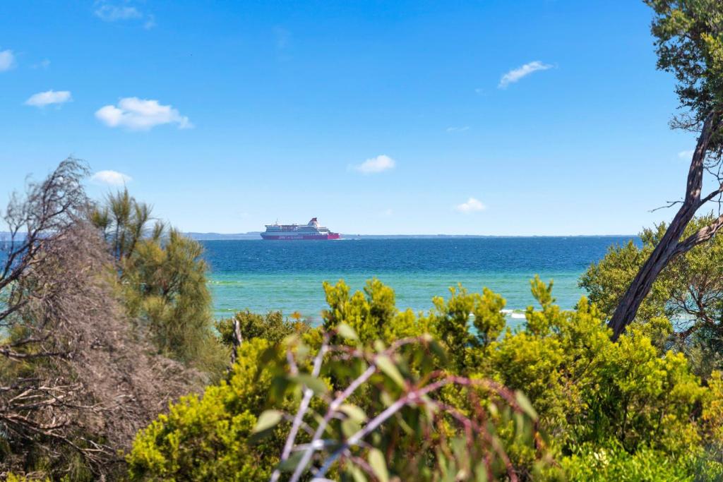 a ship in the ocean with trees and the beach at Shoreline in Tootgarook
