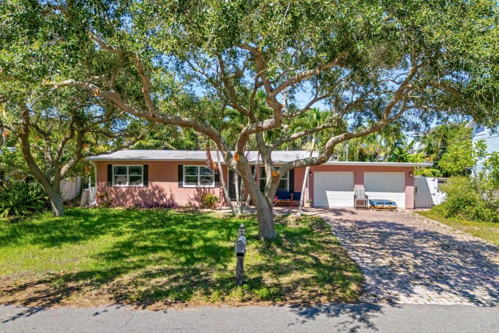 a house with a tree and a parking meter at 1375 Bay Shore Drive in Cocoa Beach