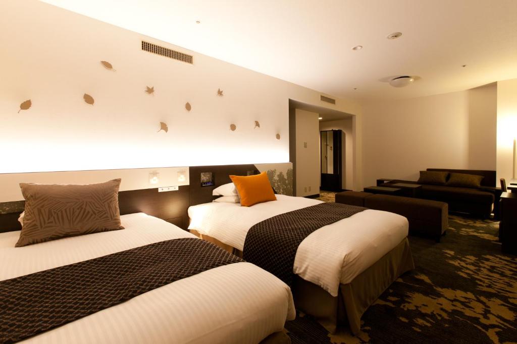 Postel nebo postele na pokoji v ubytování Toyama Excel Hotel Tokyu