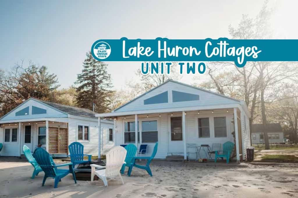 a tiny house with blue chairs in front of it at New renovated bathroom & new roof - Lake Huron 2 in Lincoln Junction