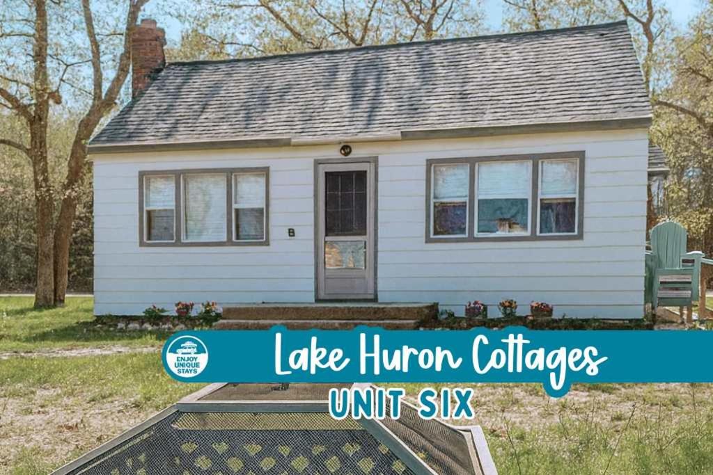 a small white house with the words lake honor villages unit six at Lake Huron Cottage 6 - 3 Bed 1 Bath in Lincoln Junction