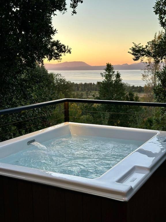 a jacuzzi tub on a balcony with a view at Monolito, Pucón - Vista la lago y spa in El Cerrillo