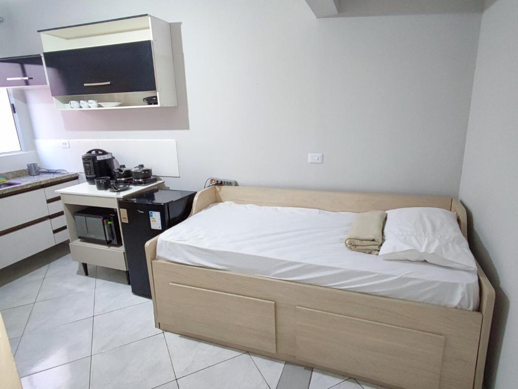 Ένα ή περισσότερα κρεβάτια σε δωμάτιο στο Casa Studio n2 São jose dos campos