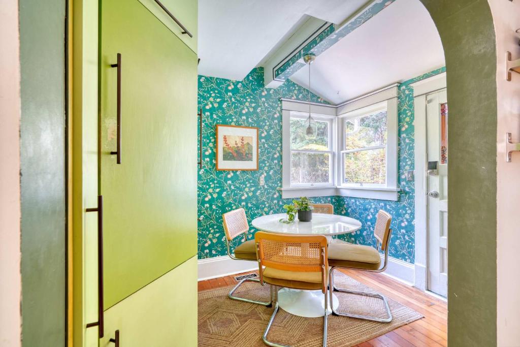 a dining room with green walls and a table and chairs at Spacious 4BR - Walkable - Funky PDX Vibes in Portland