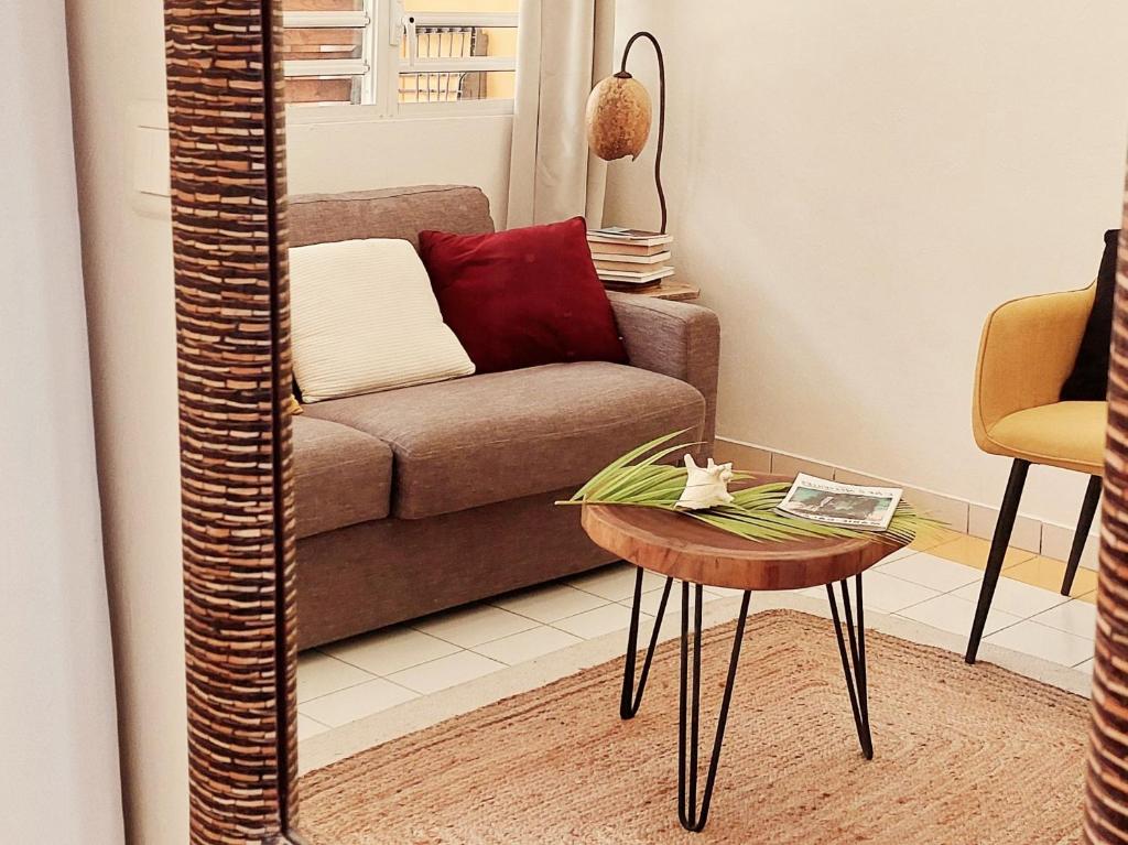 a living room with a couch and a table at Akamao in Grand-Bourg