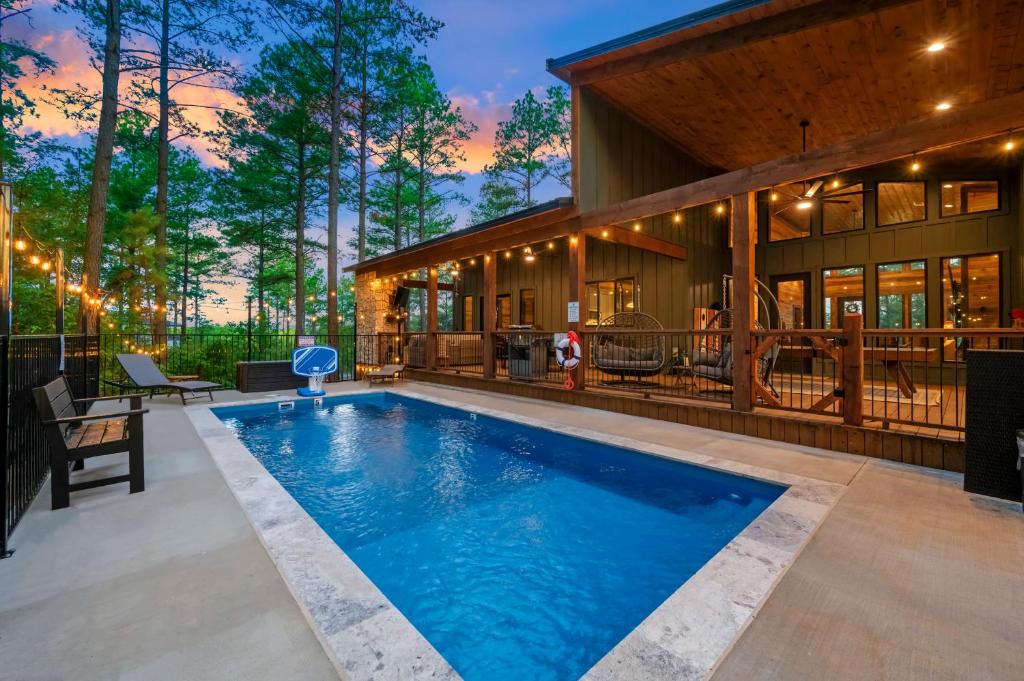 a swimming pool in the backyard of a house at Nectars Ridge - Heated Pool, Hot Tub, Ping Pong, Arcade in Broken Bow