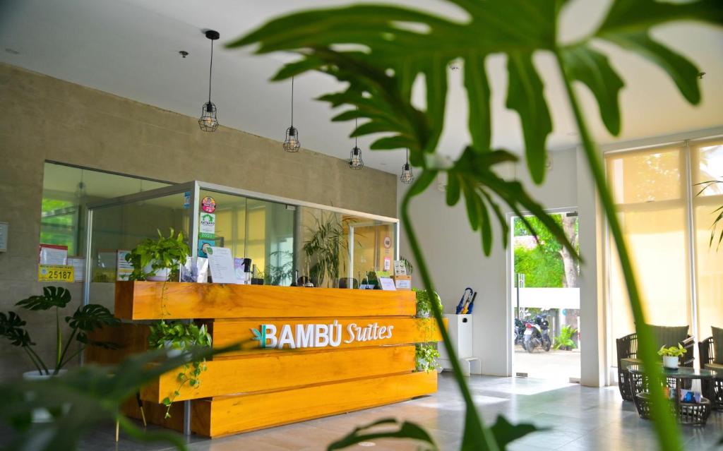 a store with a wooden counter with plants in it at Bambu Suites in Puerto Princesa City