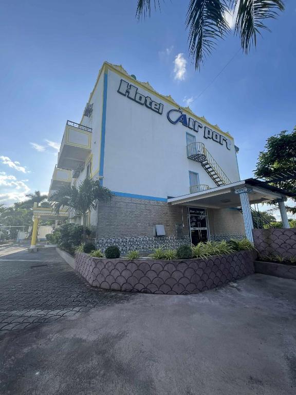 a hotel with a large sign on the side of it at Csm Clark Hotel in Sampong