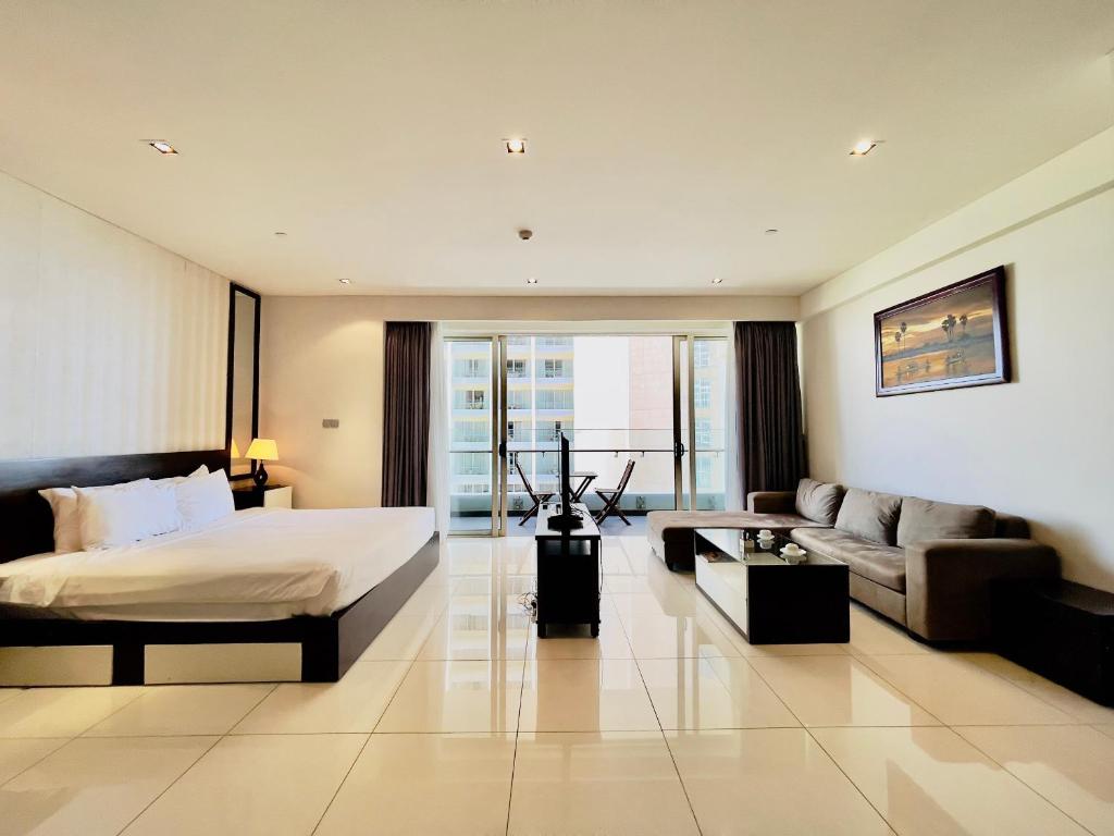 a hotel room with a bed and a couch at Central Nha Trang Apartment in Nha Trang
