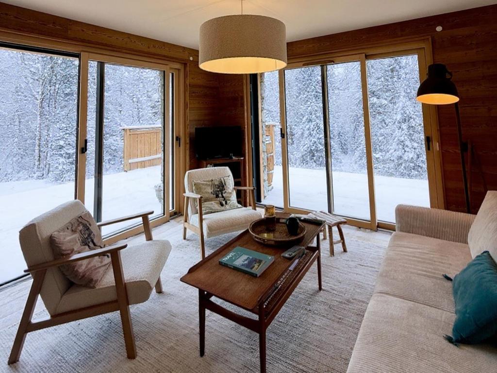 a living room with a couch and chairs and a table at Appartement 3 Chambres avec Terrasse et Parking à Arâches-la-Frasse, Animaux Bienvenus - FR-1-836-41 in Les Carroz d'Araches