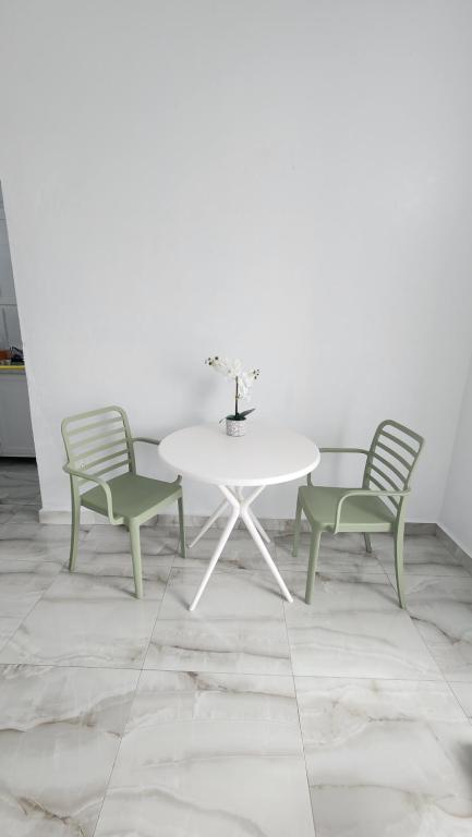 a white table and two chairs and a white table and chairs at Las Palomas Residences in San Juan