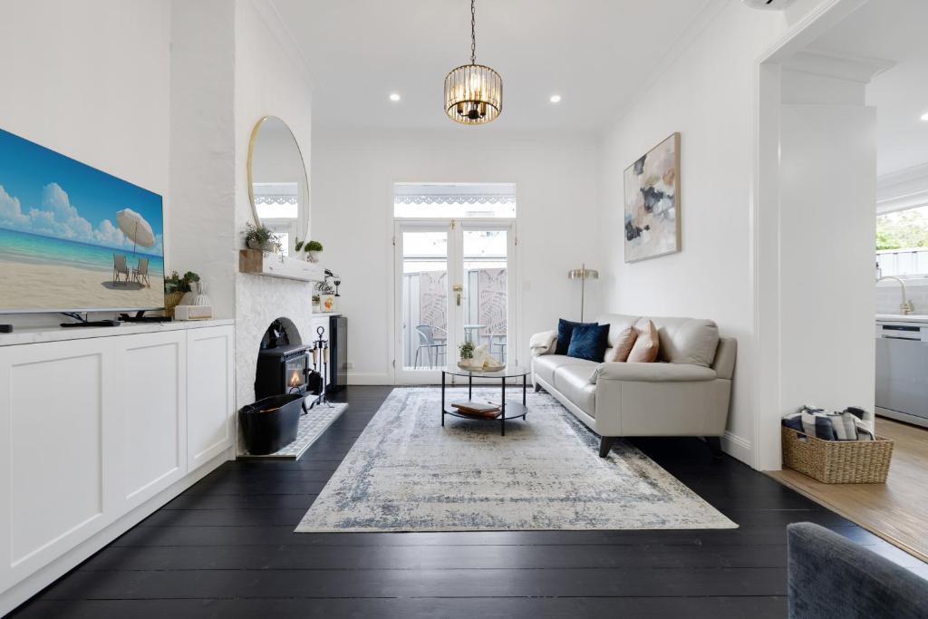 a living room with a couch and a fireplace at Courthouse - Family Retreat Near Bendigo CBD in Bendigo