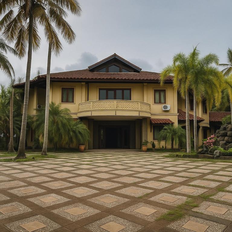 a large house with palm trees in front of it at Athaya Beachside Villa in Kadujulang