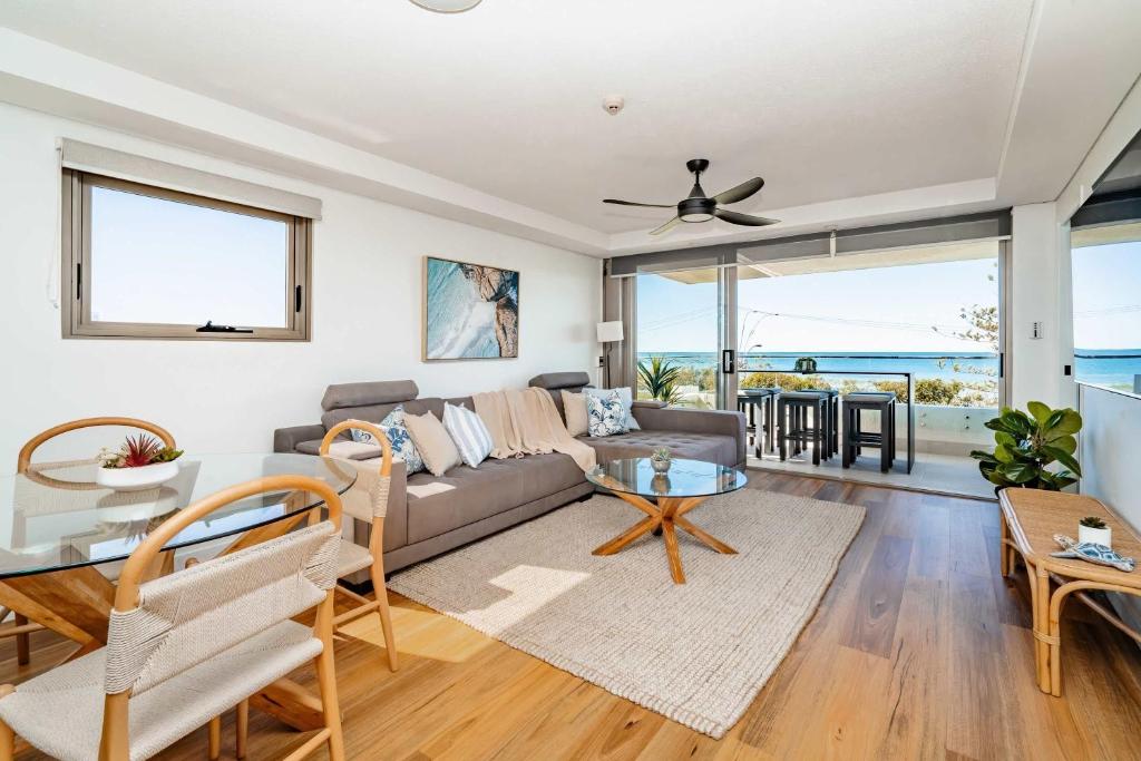 a living room with a couch and a table at Shara Seaside Oasis - Alex Beach 3BD Apartment in Alexandra Headland