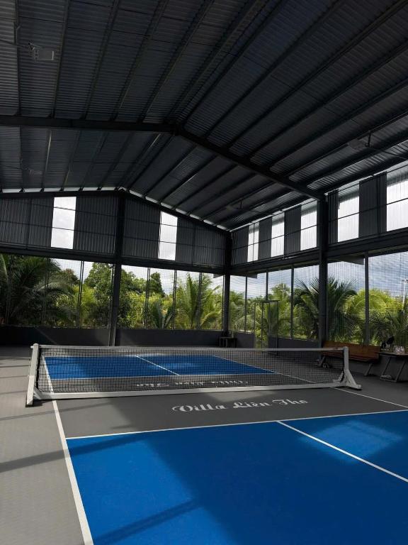 a tennis court with a net on a court at Villa Lien Tho in Phú Quốc