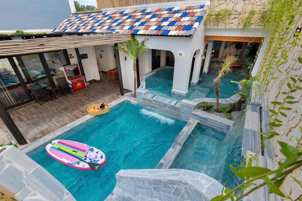a house with a swimming pool with a boat in it at Sun Villa Resort Mini - Trệt Không Lầu - Full Giải Trí in Vung Tau