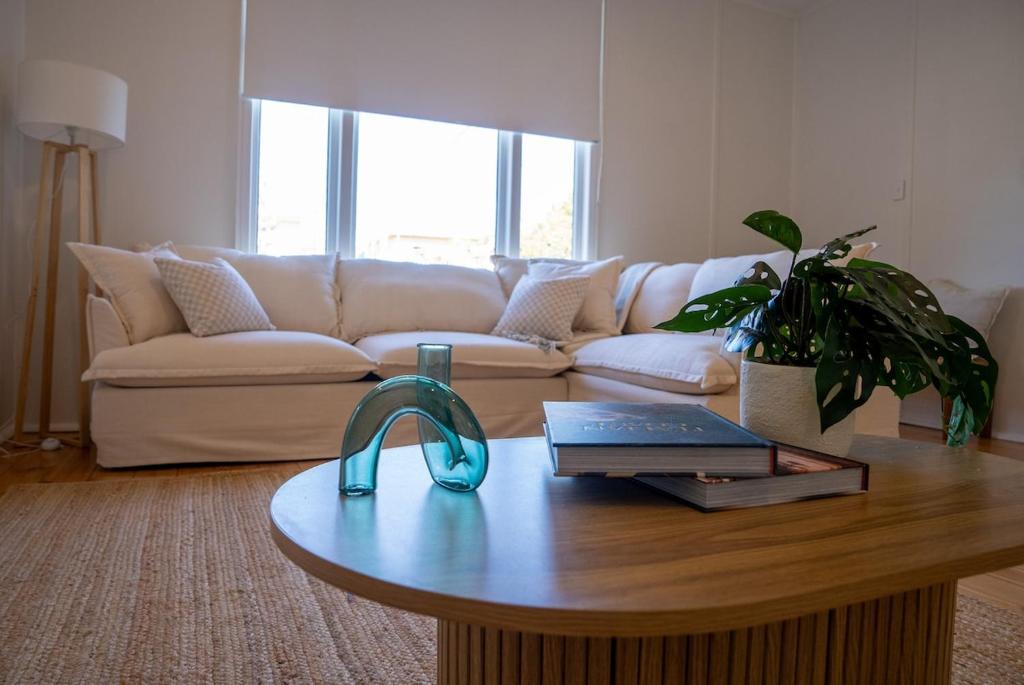a living room with a couch and a coffee table at Coastal Escape 3BR 2BA Family Retreat in Sellicks Beach