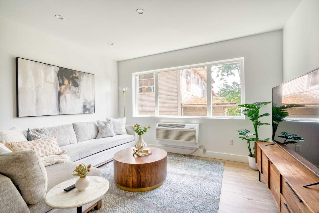 a living room with a couch and a table at Stay Portland - Stylish Luxe Suite N Williams & Alberta Districts in Portland