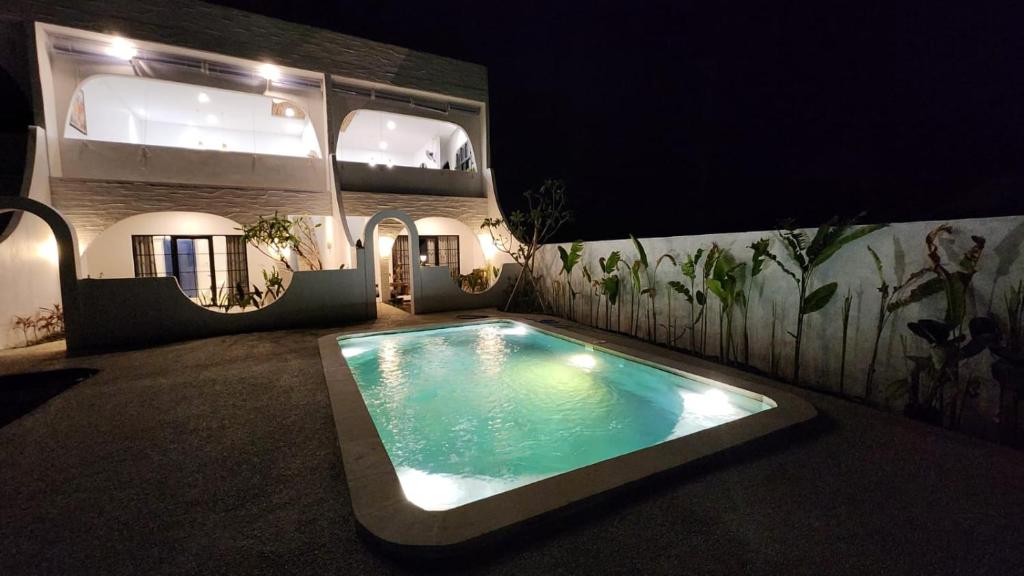a swimming pool in the middle of a house at night at Bnaya Villas Riverside in Amed