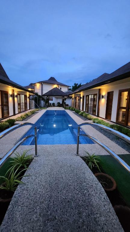 a house with a swimming pool at night at Panglao Ramyer Villa 2 in Sampong